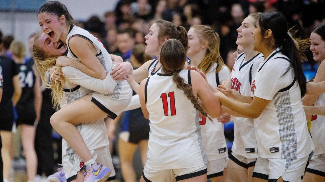Boise junior Avery Howell, left, embraces sophomore Alison Turcke after the Brave clinched their state tournament berth with a 54-47 win over Timberline in the 5A District Three Tournament semifinals Saturday at Timberline.