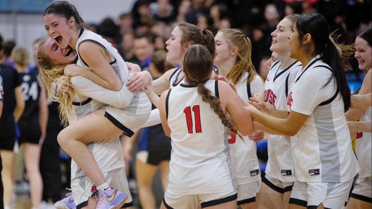 Boise junior Avery Howell, left, embraces sophomore Alison Turcke after the Brave clinched their state tournament berth with a 54-47 win over Timberline in the 5A District Three Tournament semifinals Saturday at Timberline.
