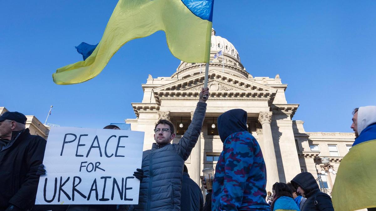 Marina Yaroshchuk holds a sign reading “peace for Ukraine” and her husband Yaroslav Yaroshchuk holds a Ukrainian flag as they stand outside of the Idaho Capitol Building on Saturday, Feb. 26, 2022 to rally against the Russian invasion of Ukraine.