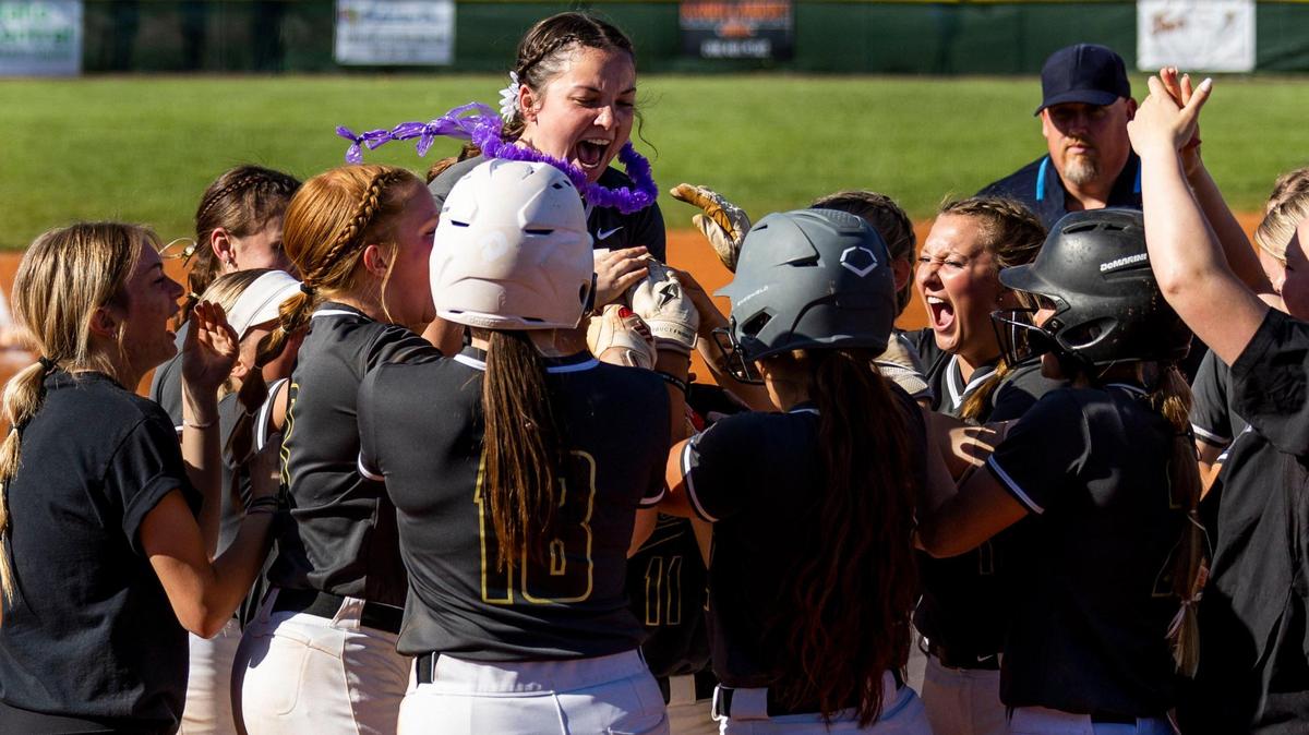 Kuna sophomore Rylee Mangum’s teammates smother her with praise after she crosses home plate following a three-run home run in Kuna’s 8-4 win over Capital in the 5A District Three championship game Friday at Eagle High School.
