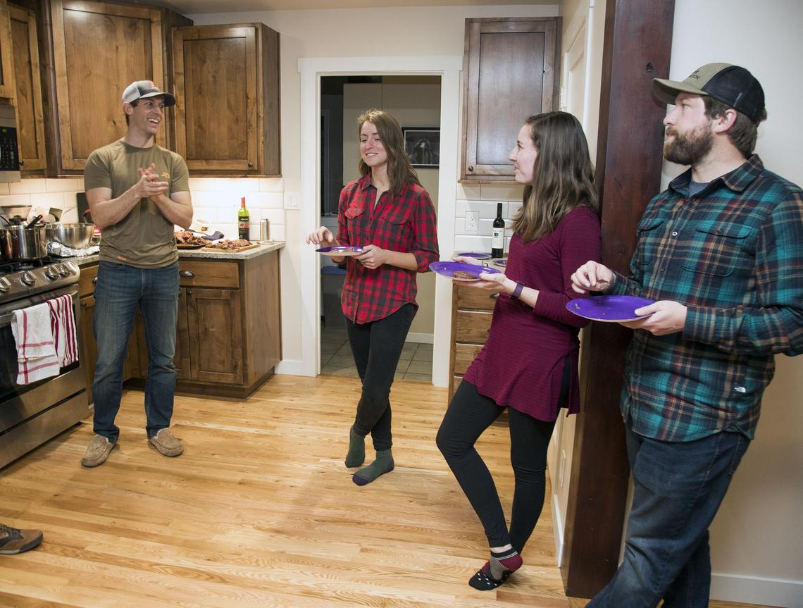 Brad Brooks, left, and his wife Angie (not pictured) welcome fellow wild game foodies Becca Aceto, Alex Rheault and his brother Brian Brooks, right, among other hunters for a dinner night at their Boise home Friday, Jan. 18, 2019. Among various sidedishes, they enjoy smoked duck from a recent hunting trip, as well as deer stroganoff, elk nachos and meatballs.