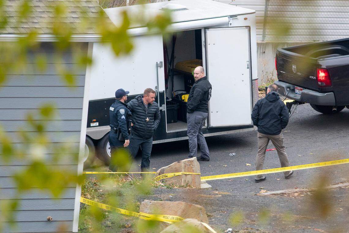 Officers investigate a homicide at an apartment complex south of the University of Idaho campus on Sunday.