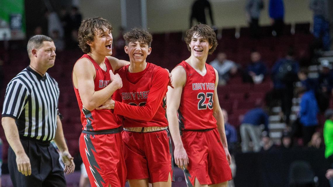 Owyhee sophomores Cameron Downie, left, Jayce Allen and Jackson Rogers share a laugh in the final seconds of a 58-51 win over Mountain View in the 5A District Three boys basketball tournament championship game.