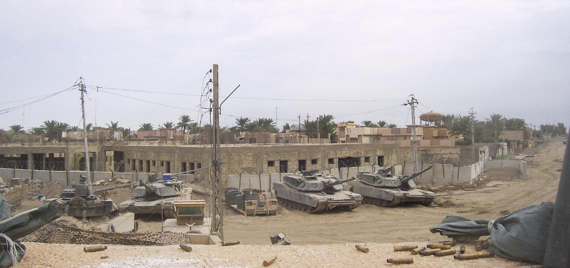 The view from the rooftop of the command house at Combat Outpost Falcon looking toward the entry control point in 2004. The tanks were parked across from the command house, which caused a dangerous scramble to get to them in an attack. “Every time we had to respond with our tanks, the crews responsible for rolling out would be at risk from small arms fire and sniper fire because as you can see, the enemy has a pretty clear view,” said Jared Hatch. “We did not live on a secure base. We lived on the front lines.” The tanks are in front of what was to be a school but never was finished. “Beyond that building is enemy territory as far as the eye can see,” said Hatch.