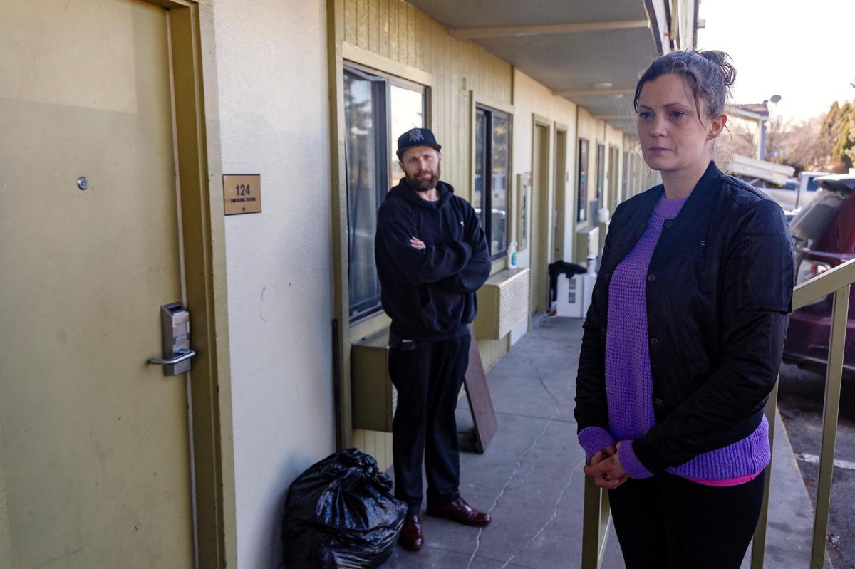 Adam and Rachel Church stand outside of the Airport Inn hotel where they live and Rachel works as a manager. Residents of the hotel are being evicted.