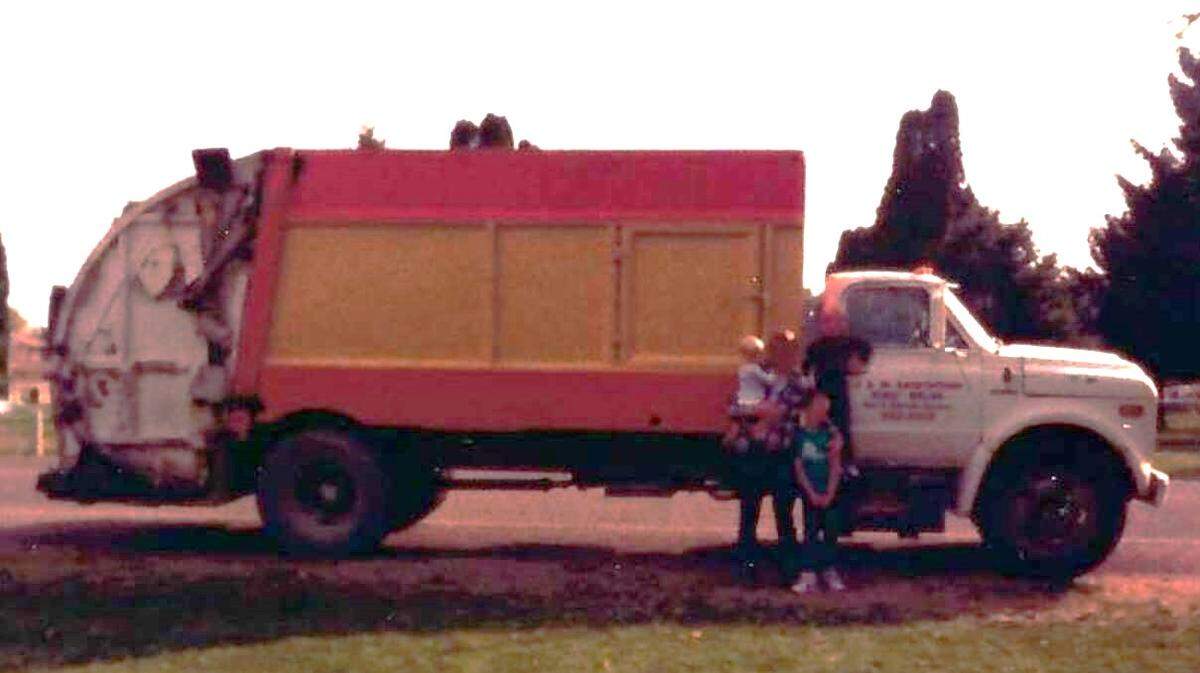 Tim Gordon and his children stand next to a J&M Sanitation truck in September 1986 when he and his wife, Belinda, purchased the business that collects trash and recycling for the cities of Kuna and Melba and some unincorporated parts of Canyon County. Now, 38 years later, J&M collects all of Kuna’s trash and recycling with 100% electric vehicles.