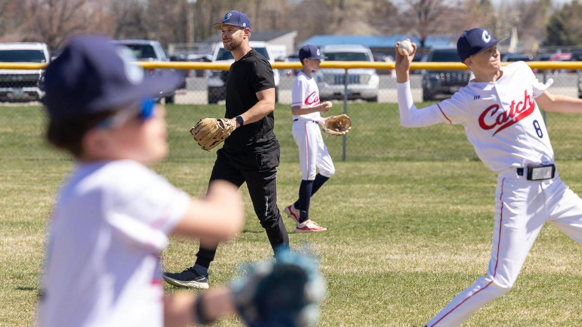 David McMenomey helps his youth baseball team, the Sawtooth Catch, warm up before a game. McMenomey says his passion for youth sports has recently become a “divine calling” to build a massive sports complex in Kuna.