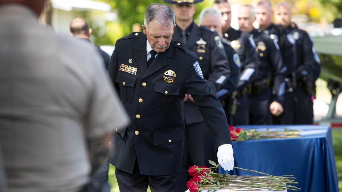 Caldwell County Sheriff Kieran Donahue places a rose as law-enforcement officials honor fallen Idaho officers at a memorial ceremony at Canyon Hill Church of the Nazarene Community Park in Caldwell, Friday, May 20, 2022.