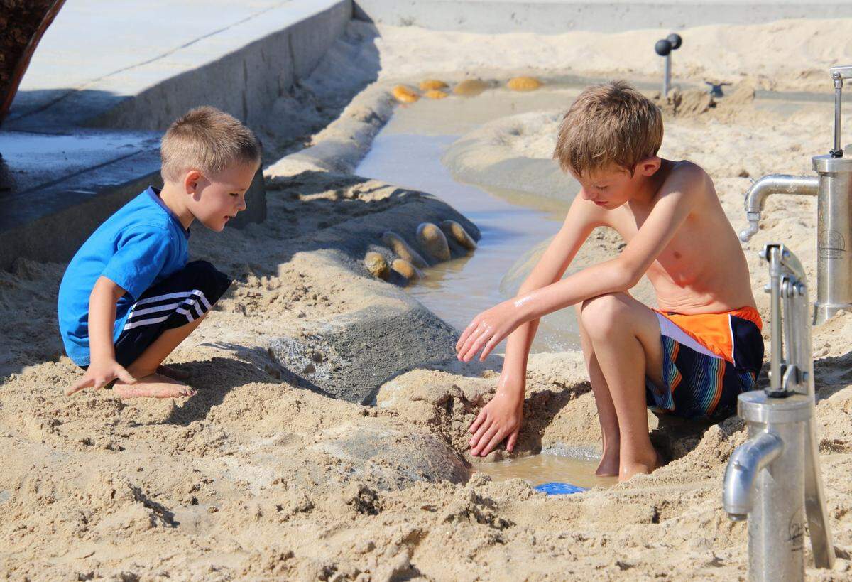 Children play in the sand and water area at Meridian’s Discovery Park.