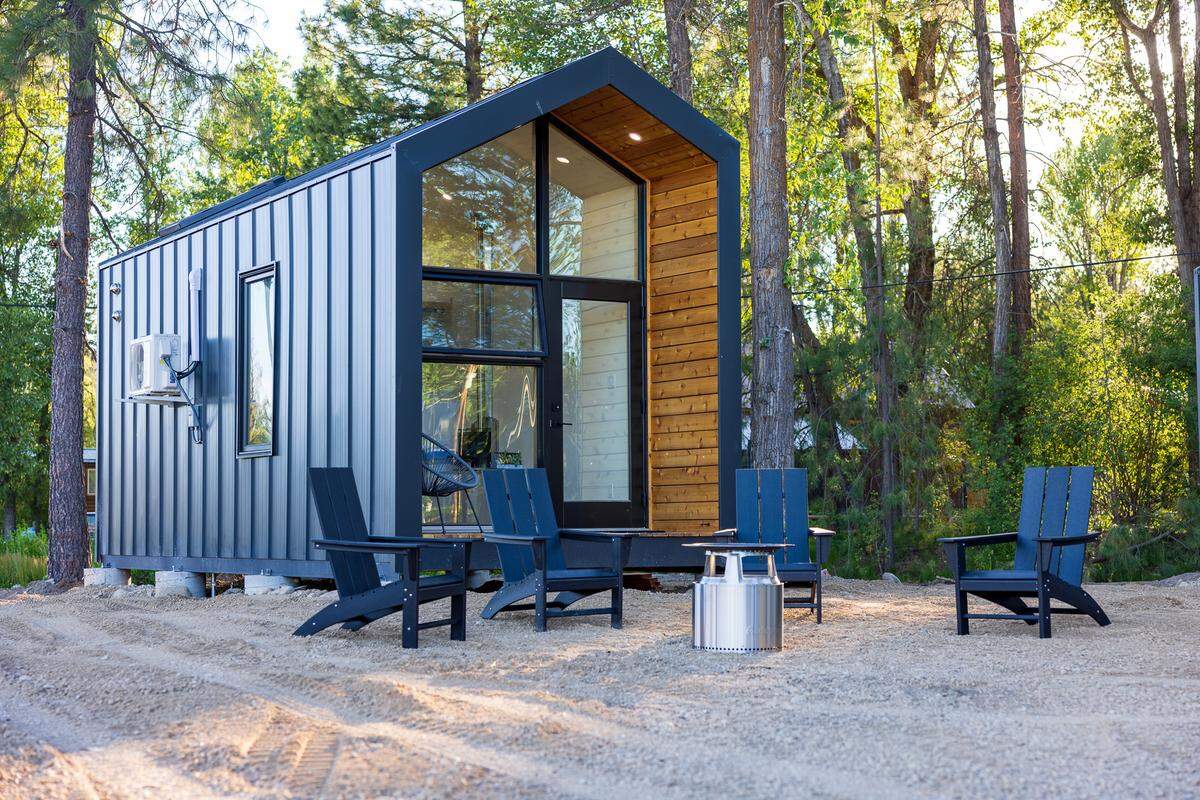 The outside of each home includes a deck, chairs, and a smokeless fire pit.