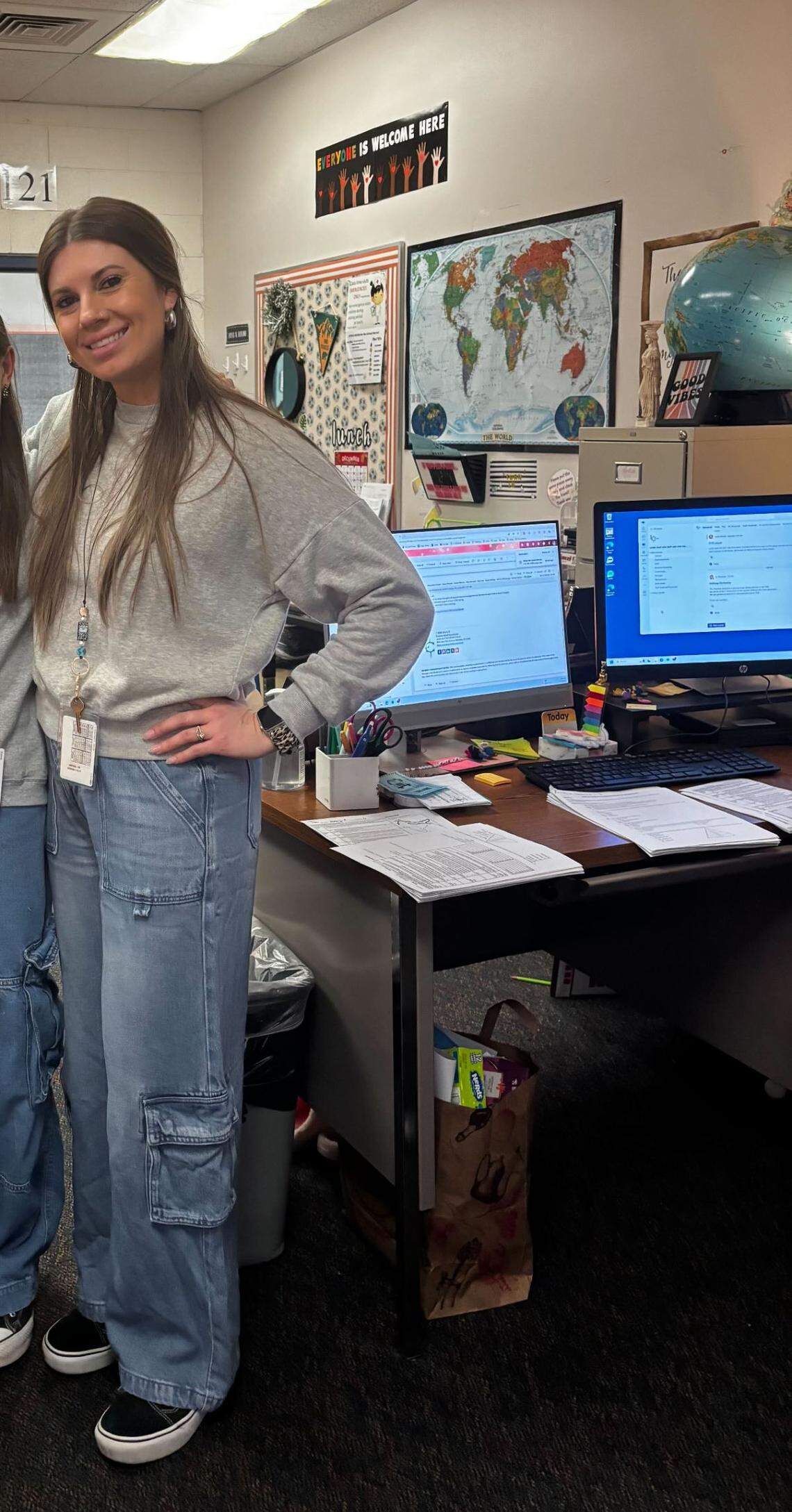 Sarah Inama photographed on a school spirit dress-up day in which teachers dressed like students. Her sign can be seen in the background.