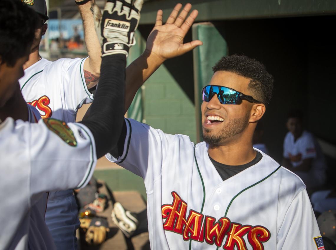 Yorvis Torrealba, from Venezuela, congratulates teammate Ezequiel Tovar as he scored. Torrealba plays for the Boise Hawks in the footsteps of his father, who played for the Colorado Rockies.