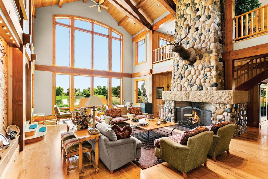 The main living area includes a vaulted ceiling, fireplace and large windows.