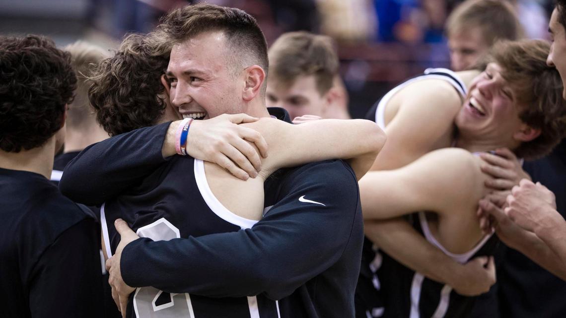 Middleton coach Andy Harrington hugs his team after the Vikings defeated Preston 47-45 for their first state championship since 1965.