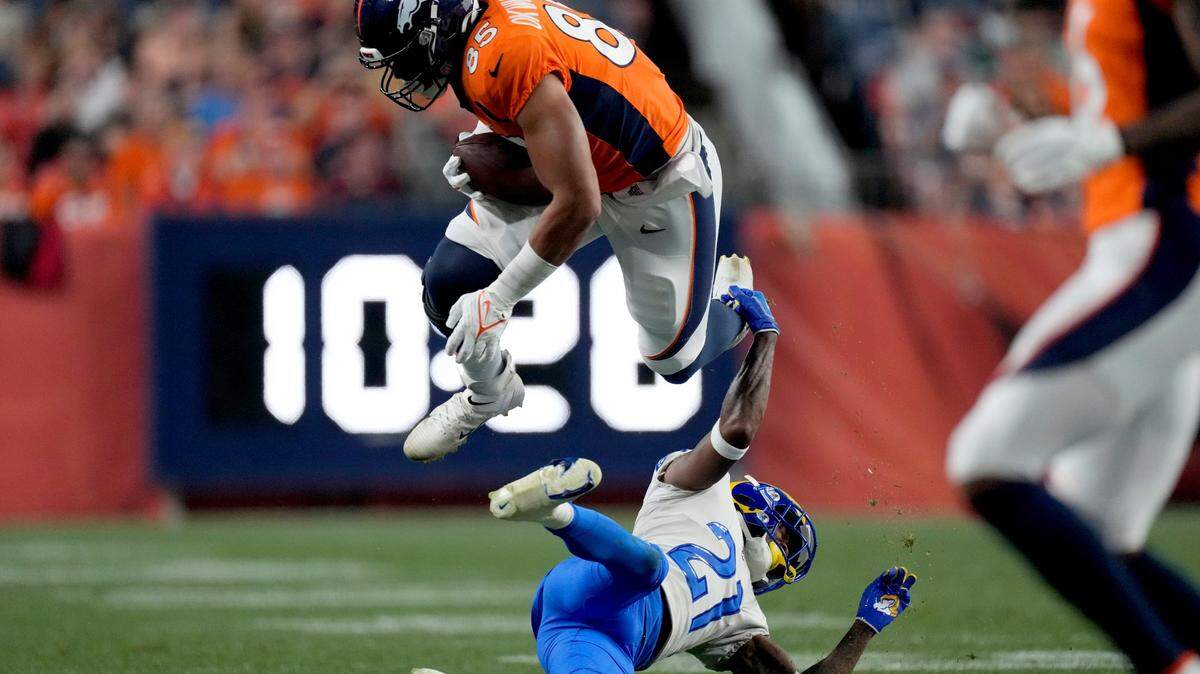 Denver Broncos tight end Albert Okwuegbunam is tackled by Los Angeles Rams cornerback Dont’e Deayon during the first half of an NFL preseason game Saturday in Denver.