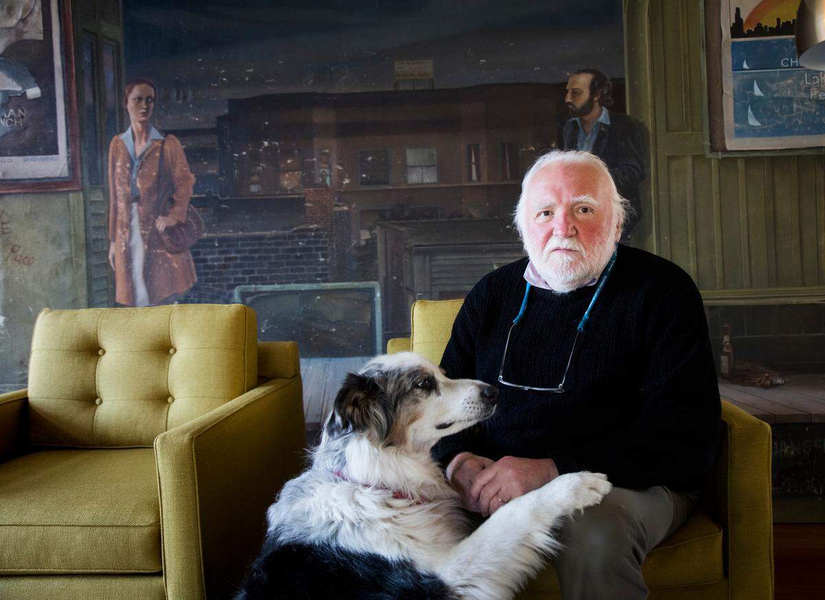 Hy Kloc, pictured in 2018, was born in a displaced persons camp in post-war Germany to parents who were Polish Jews. Kloc has long felt a need to tell his family’s story, to bear witness to the unspeakable reality of fascism and genocide, and to the blessings his family received as refugees, who arrived penniless at Ellis Island in 1949. (The painting behind him is the Belmont Street stop on the Chicago “L.”)