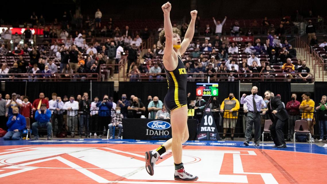 Bishop Kelly’s Christopher Martino celebrates his overtime win in the 4A 126-pound state championship. He beat Caldwell’s Hunter Bidelman 8-6 on Friday for his third straight title.