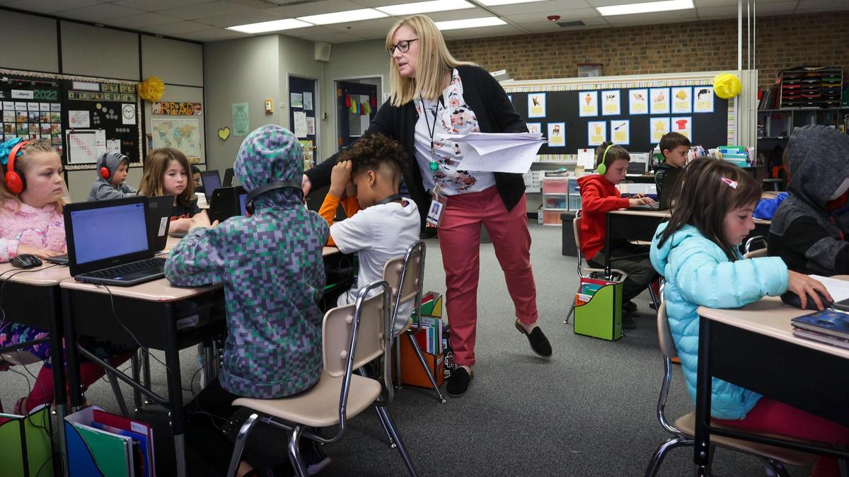 Lara Luthy hands back assignments in her classroom at Maple Grove Elementary in Boise. Idaho education officials approved a temporary rule Thursday to continue to allow funding for K-12 public schools to be calculated based on student enrollment instead of daily attendance.