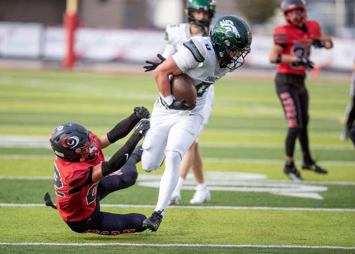 Eagle running back Noah Burnham breaks a tackle by Owyhee defensive back Cade Sauer during the game at Owyhee High School in Meridian, Friday. Oct 3, 2025. Eagle defeated Owyhee 34-20.