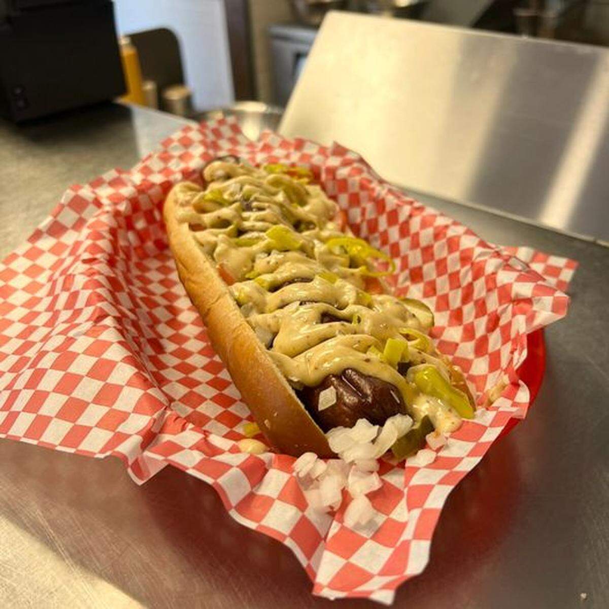 Da Bears is a foot-long beef dog with sliced tomato, pickles, pepperoncinis, raw onions and mustard aioli.