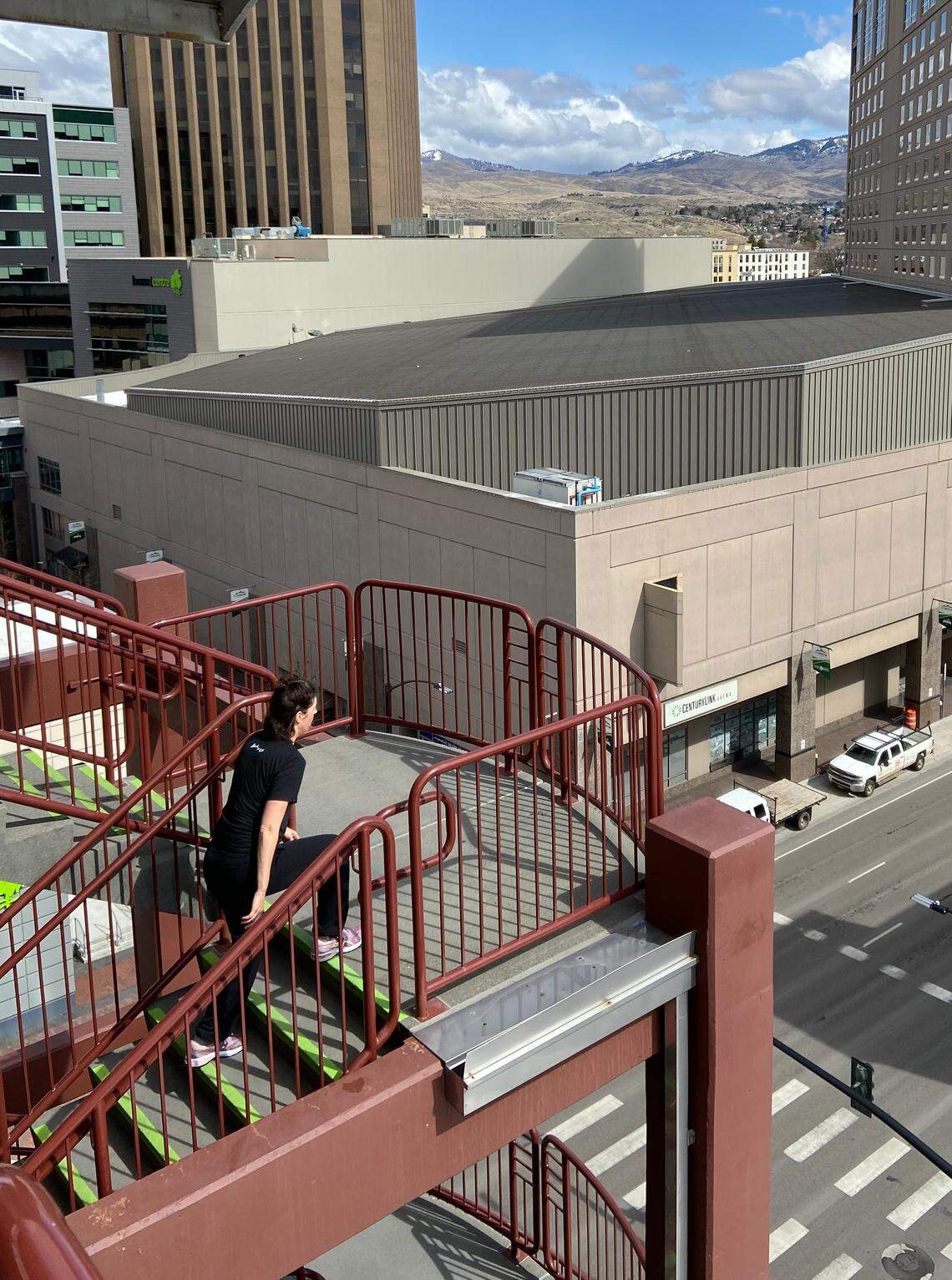 A woman works out Tuesday, climbing the stairs at the half-empty parking Garage on Ninth and Front streets in downtown Boise.