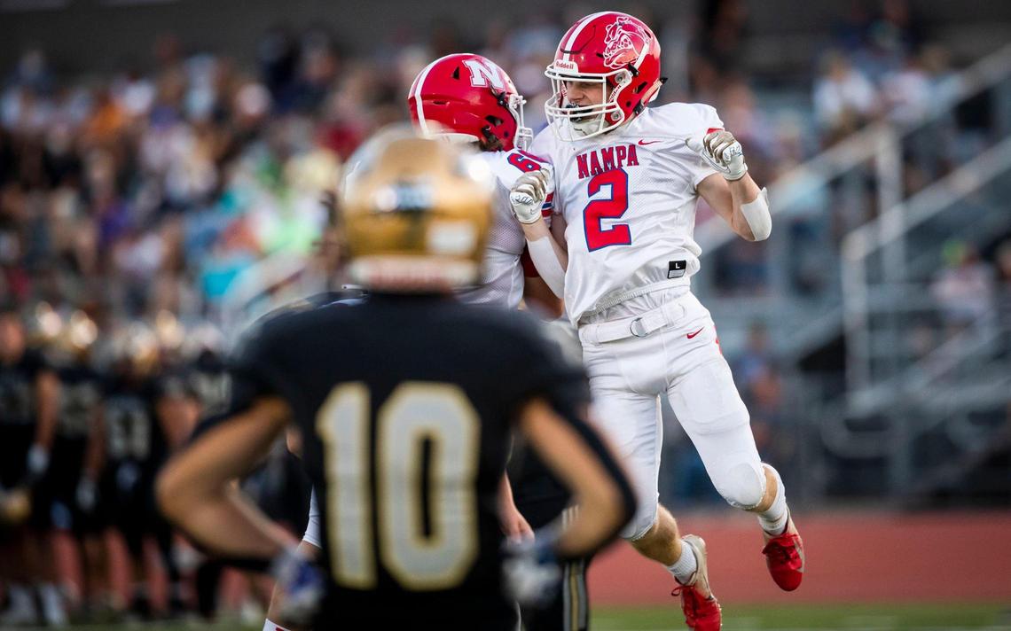 Nampa wide receiver Ty Frickey celebrates his 16-yard touchdown catch with teammate Ayden Jensen 6 seconds before halftime Thursday at Dona Larsen Park in Boise.