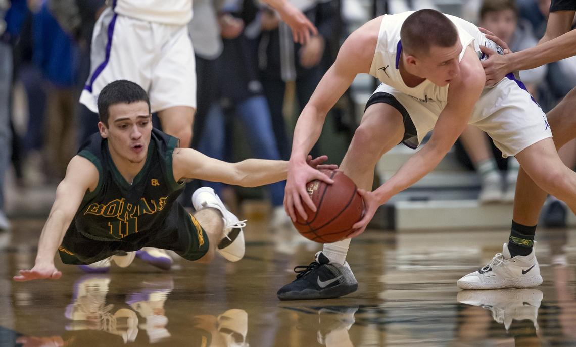 Borah senior Kyler Castro, left, and Rocky Mountain’s Jaden Hansen battle for a loose ball in the 5A District Three championship game last week.
