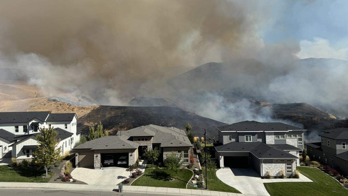 The Valley Fire burns near Harris North homes in the Boise Foothills Friday.