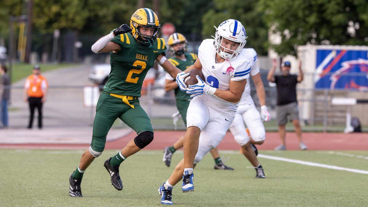 Timberline junior running back Brody Engroff makes a catch and Borah junior defensive back Kage Alexander defends in the first quarter of their football game at Dona Larsen Park, Friday, August 29, 2025.