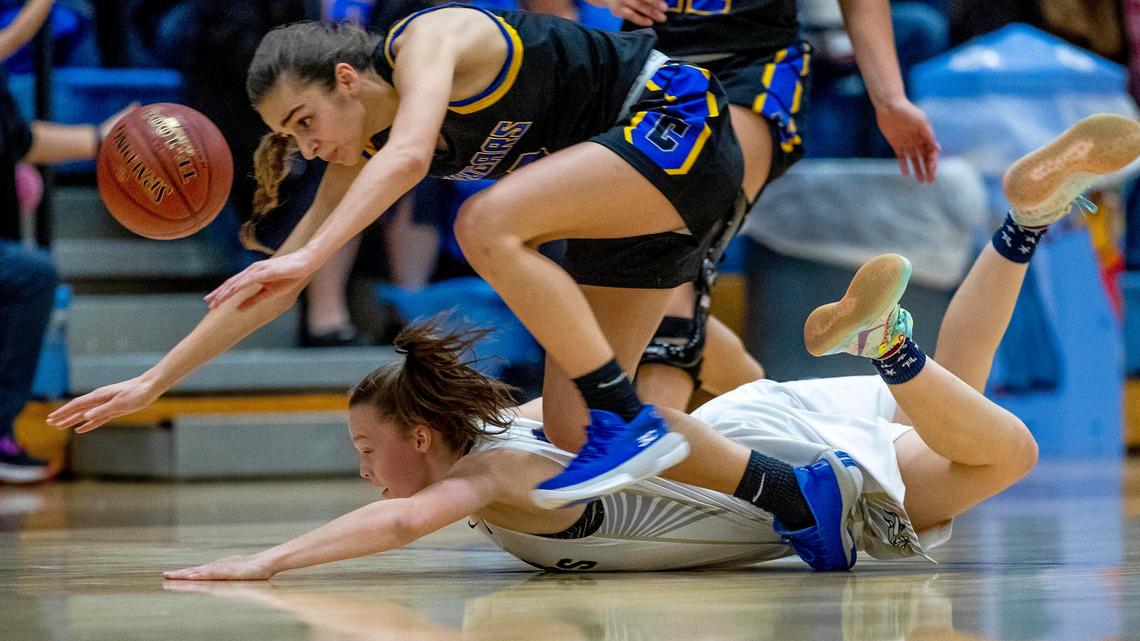 Caldwell senior Belle Bower powers over Middleton’s Ashley Campbell while in transition at midcourt during the 4A District Three girls basketball championship Thursday at Caldwell High.