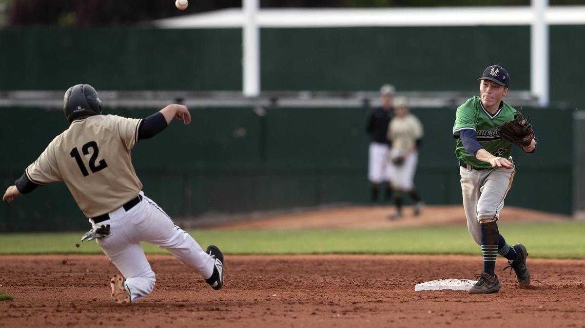 Mountain View second baseman Carson Smith converts a double play as Capital base runner Josh Berg slides in the second inning of last year’s 5A state championship game at Memorial Stadium.