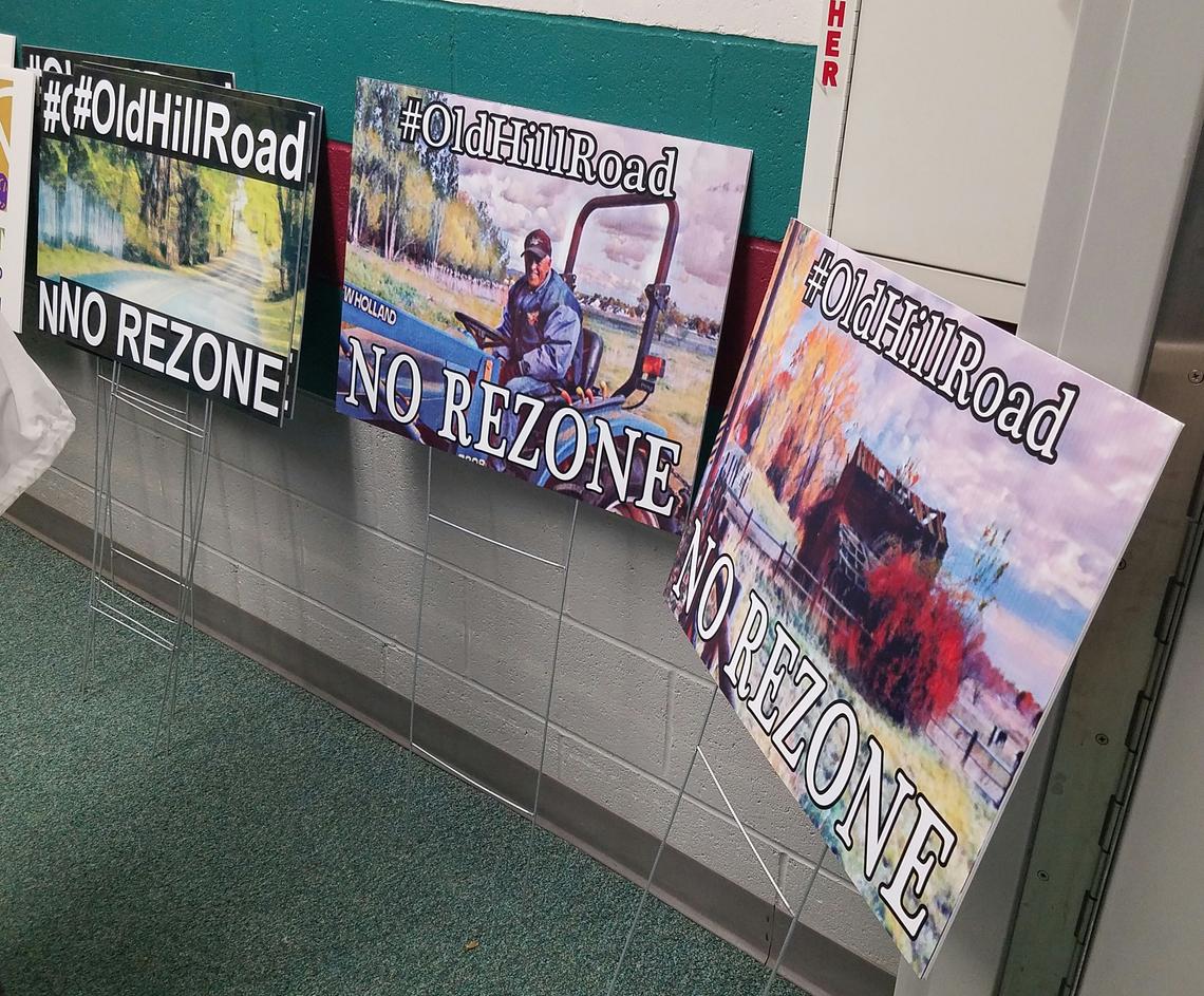 The North West Neighborhood Association handed out yard signs for people opposed to Trilogy Development seeking a zone change that would allow it to build up to eight dwelling units per acre. Current zoning on the site off West Hill Road Parkway allows two units per acre.