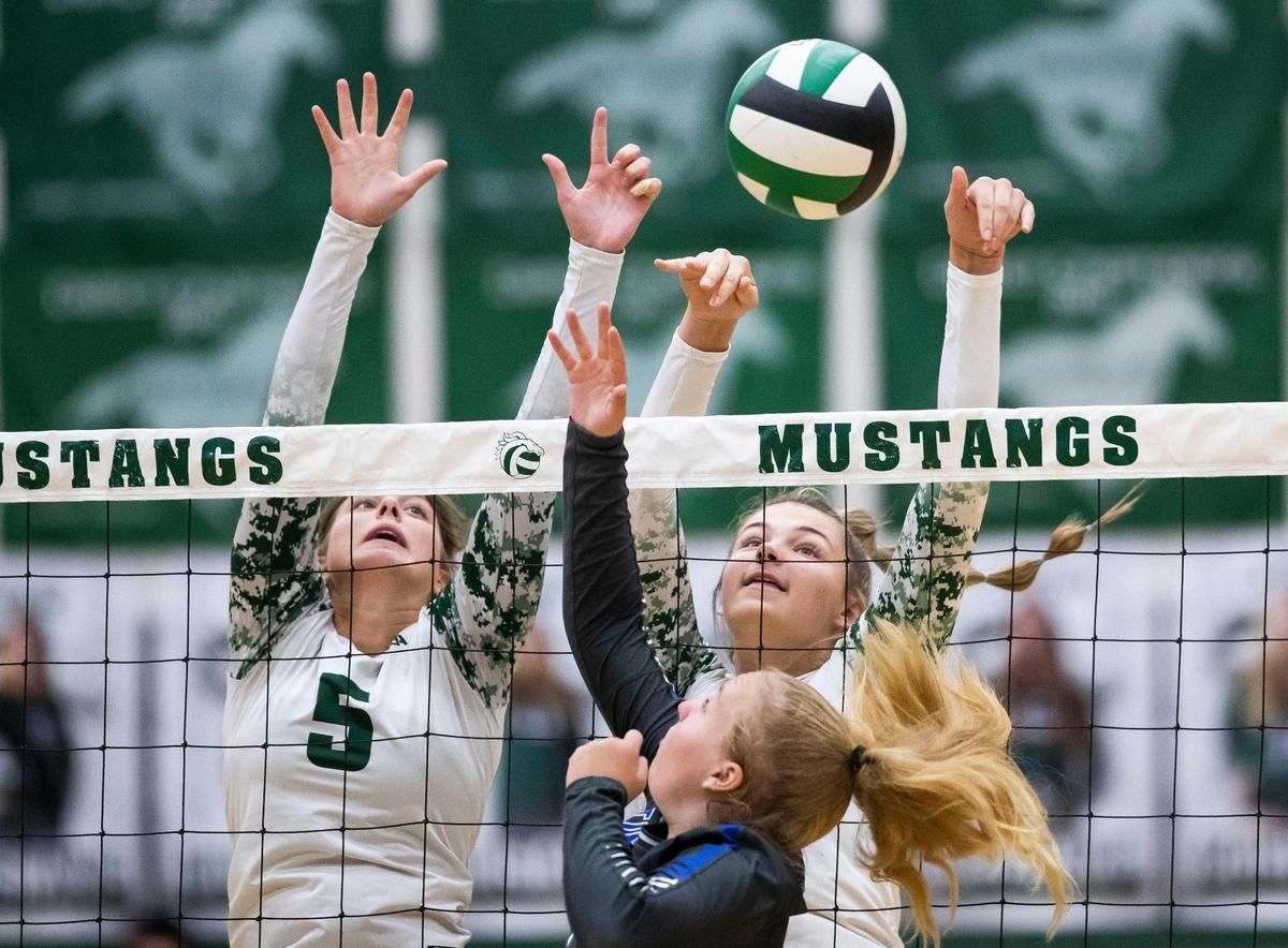 Eagle’s Liv Manning, left, and Delaney Bub block a shot in last year’s 5A District Three championship match. Both return as the Mustangs enter as the preseason favorite in the 5A SIC.