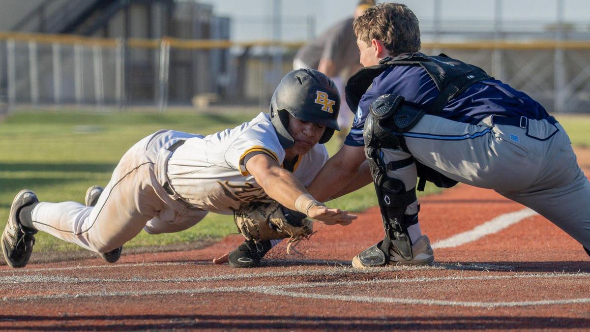 Skyview catcher Trevan Plew tags out a Bishop Kelly base runner before he can reach home plate in the 5A District Three championship game last year Vallivue High.