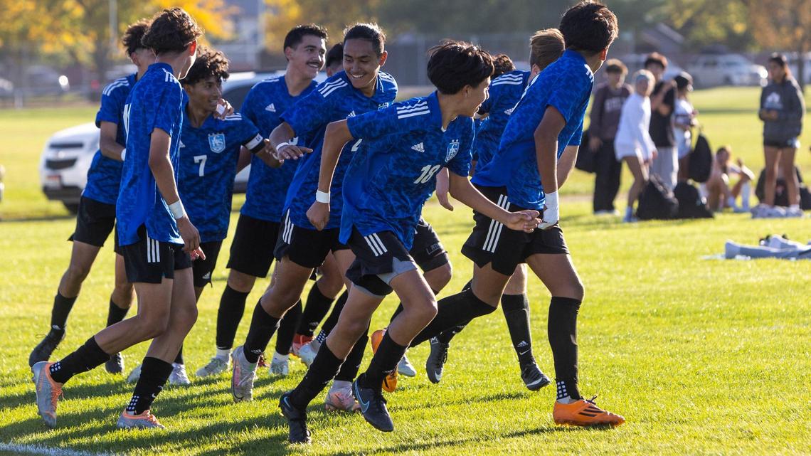 Caldwell celebrates Axel Gonzalez (7) and his opening goal Thursday during the 4A District Three boys soccer championship at Vallivue.
