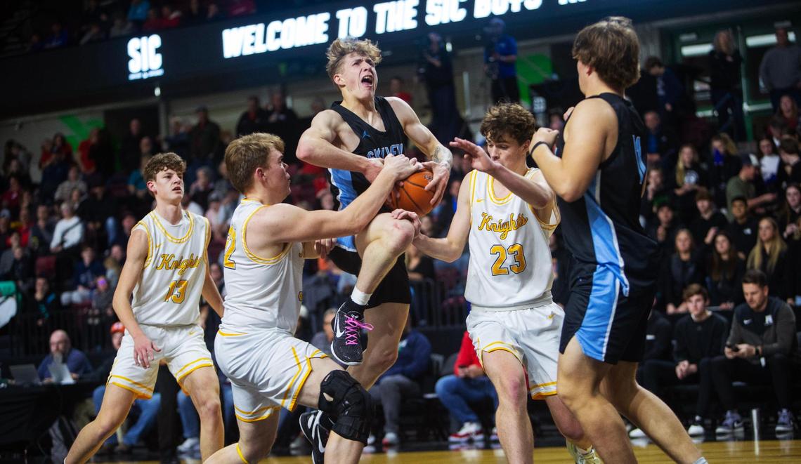 Skyview senior Eloy Chaparro is surrounded by Bishop Kelly defenders in the 4A District Three boys basketball tournament championship game Thursday at at Idaho Central Arena .
