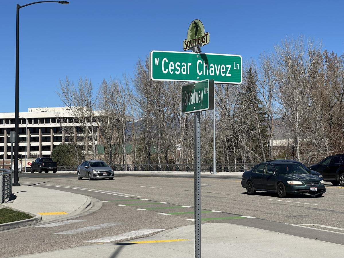 Cars drive past the intersection of Broadway Avenue and Cesar Chavez Lane next to the Boise State University campus.