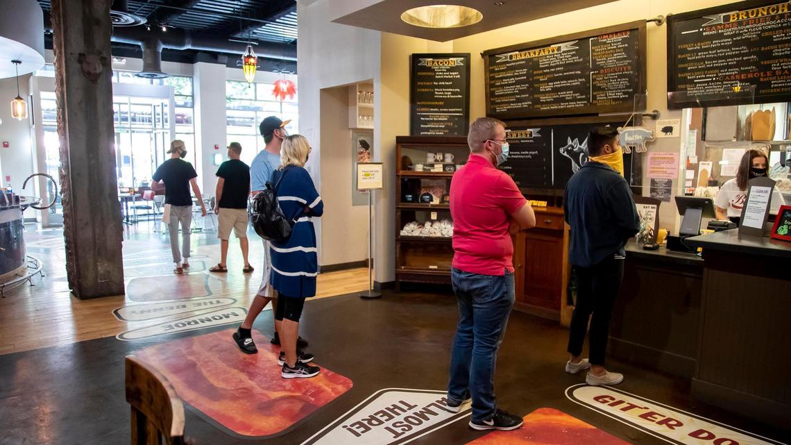 Bacon customers social distance and wear masks as they place orders for lunch. Bacon has refitted its HVAC filtration system to make the air guests and staff breath more safe.