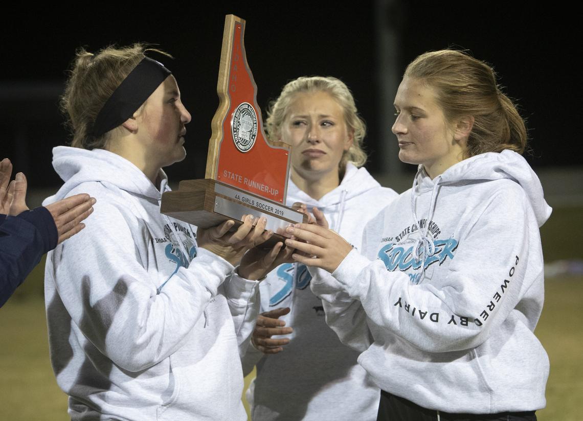 Goalie Ariel Kotte, left, Baily Davis and Kassie Gorton accept Kuna’s second place trophy with mixed emotions in the 4A state girls soccer championships. Kuna lost to Sandpoint 2-0 on Saturday, Oct. 26, 2019 at Middleton High School.