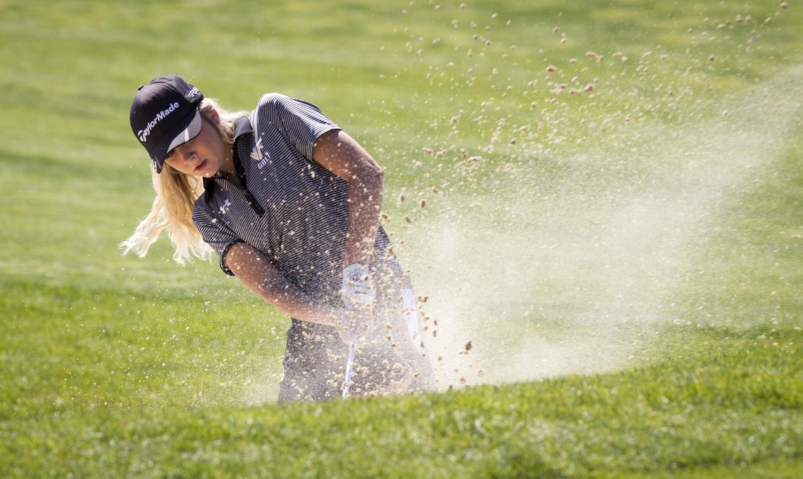 Vallivue's Sidney Johnson blasts out of a bunker at the 4A District Three girls golf tournament at RedHawk Golf Course in Nampa on Monday.