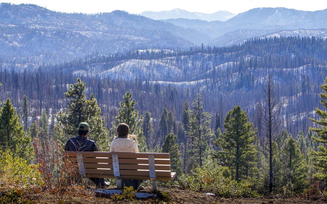 Brenda Fitzgerald Pawelek and Surat Nicol, both of Boise, take in the view of the Boise National Forest from an installed park bench a stone’s throw from the Hennessy Yurt. Idaho Parks and Recreation officially opened the new yurt Thursday, Nov. 8, 2018.