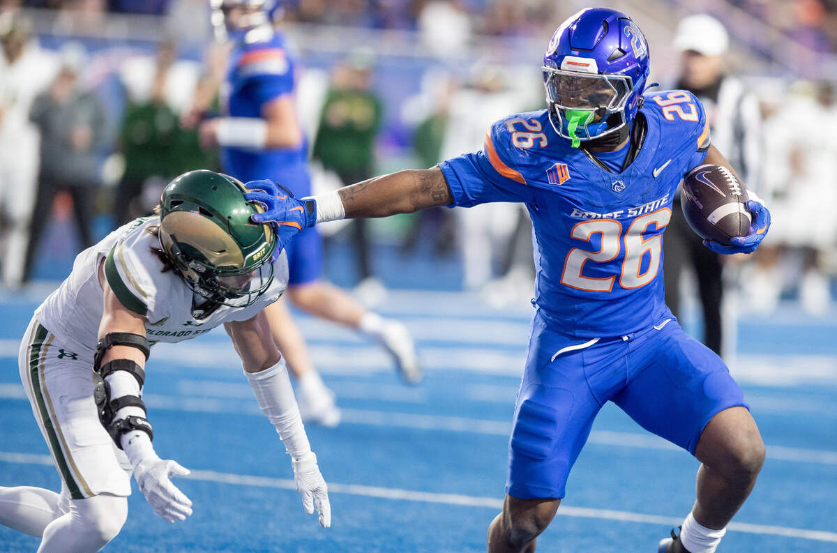 Boise State running back Sire Gaines fights off a tackle from Colorado State defensive back Ayden Hector on his way to a 3-yard touchdown run.