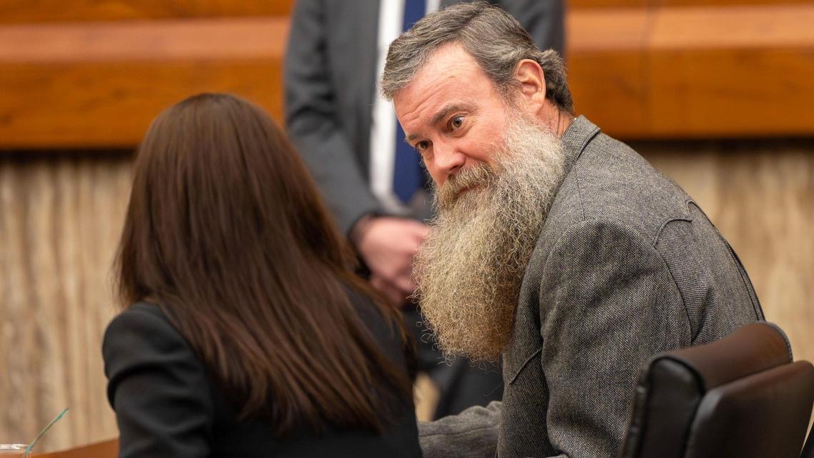 Justin Oleson, right, former Custer County prosecutor, speaks with his attorney, Michelle Points, as they present arguments against the Idaho State Bar in January before the Idaho Supreme Court in Boise.