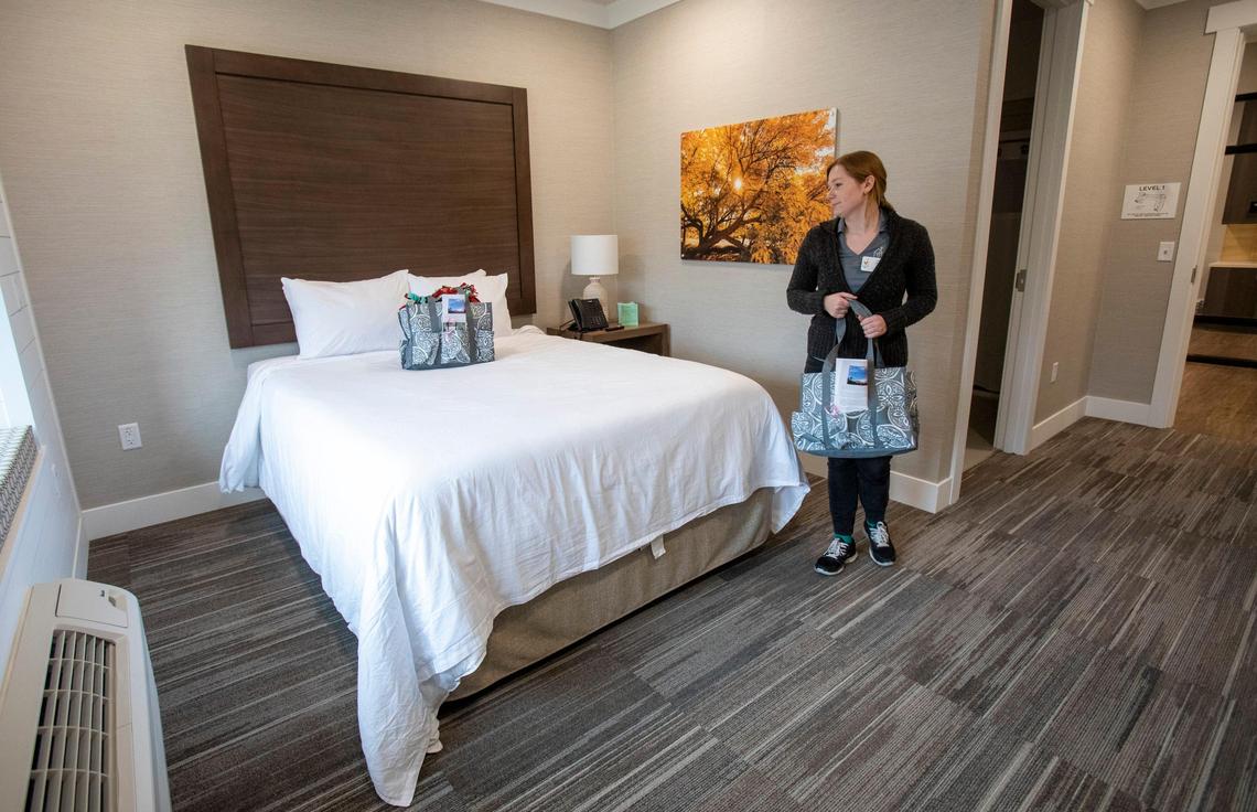 Each family that stays at the Ronald McDonald House gets a welcome bag, and Taylor Munson prepares for guests. The new house, which can serve 47 families, has one- and two-bed rooms.