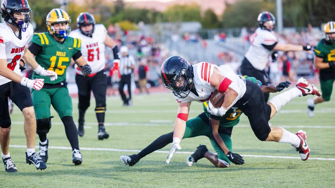 Borah defensive back Booker Barrus stops Boise running back senior Grant Spillman in the first quarter Thursday at Dona Larsen Park.