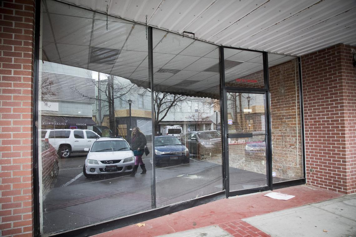 A multi-storefront building on 1st Street South in downtown Nampa is vacant, in contrast with the facade of the about-to-be-opened Mesa, a taco restaurant and tequila bar, reflected in the windows.