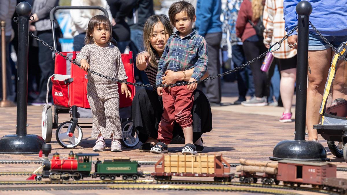 Aya Wills with her children Ariel, 2, left, and Atreyu, 4, right, watch model trains at the Boise Depot 100th anniversary celebration.