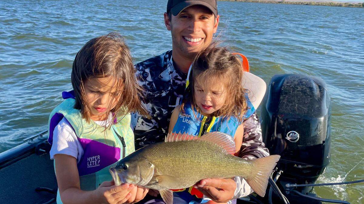 Skye Rodriguez admires the first big fish of her angling career — a 3-pound smallmouth bass caught at C.J. Strike Reservoir with Mom, Dad and older sister Quinn.