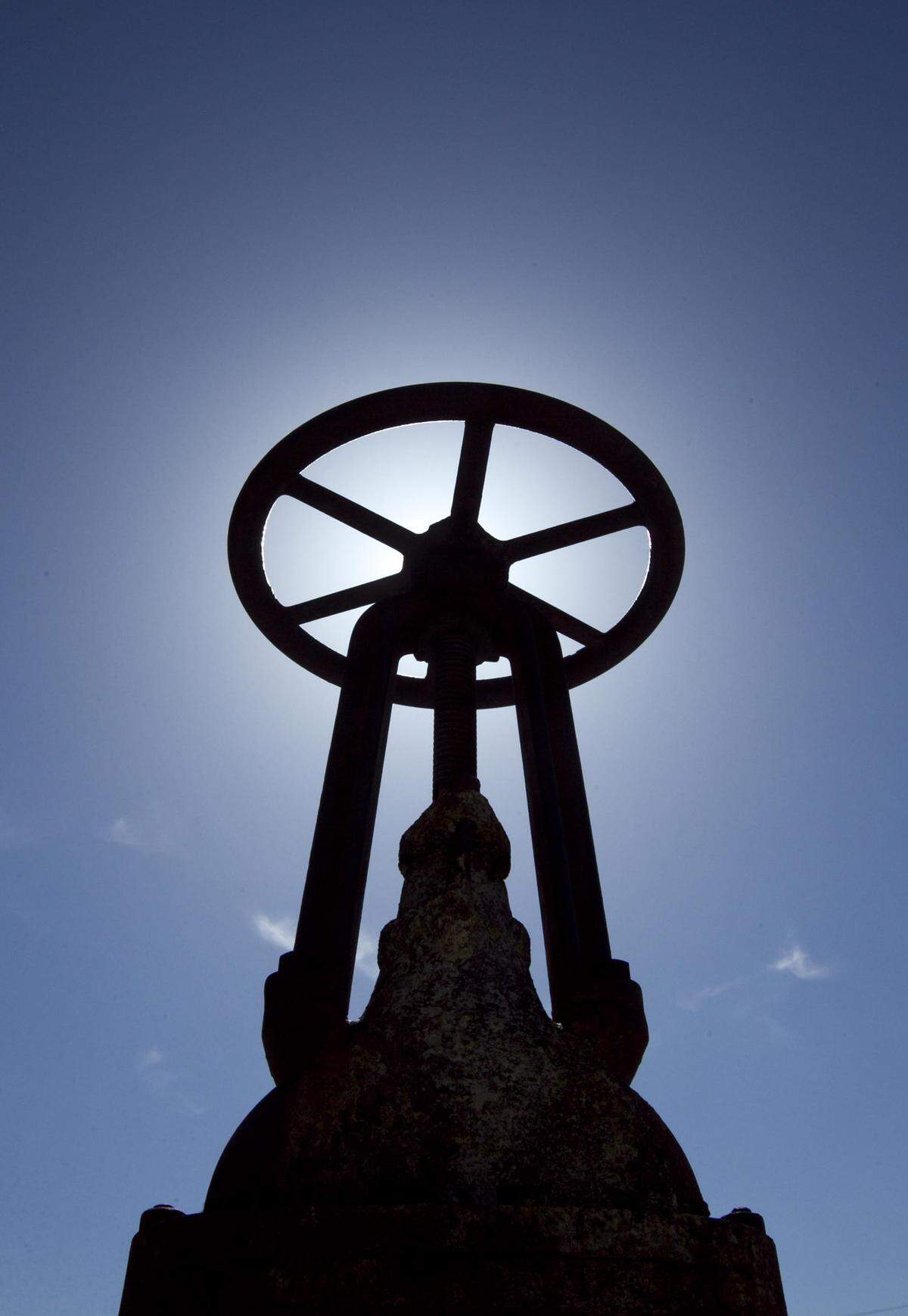 An old valve wheel from the Boise Warm Springs Water District stands in front of the company's pump house as an exterior decoration.
