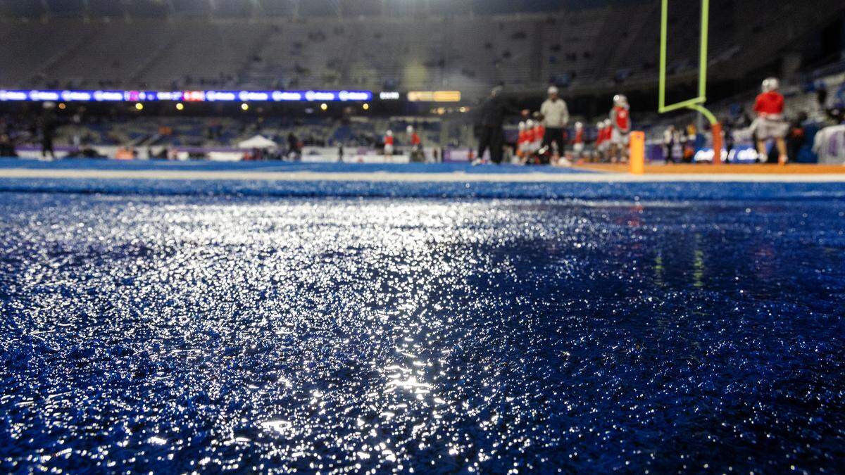 Rain soaks the blue turf of Albertsons Stadium just before the start of Friday night’s game.